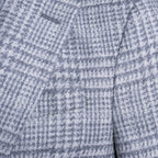 Close-up of a textured fabric with a small-scale blue and white houndstooth pattern. Sand Copenhagen Blazer available at Sakks Menswear in Southampton.