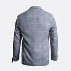 The back view of a men's blazer in a gray and white windowpane plaid pattern, displayed on a clean light gray background. Sand Copenhagen Blazer available at Sakks Menswear in Southampton.