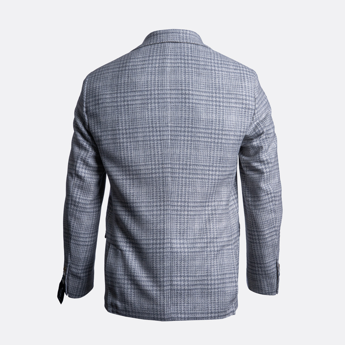 The back view of a men's blazer in a gray and white windowpane plaid pattern, displayed on a clean light gray background. Sand Copenhagen Blazer available at Sakks Menswear in Southampton.