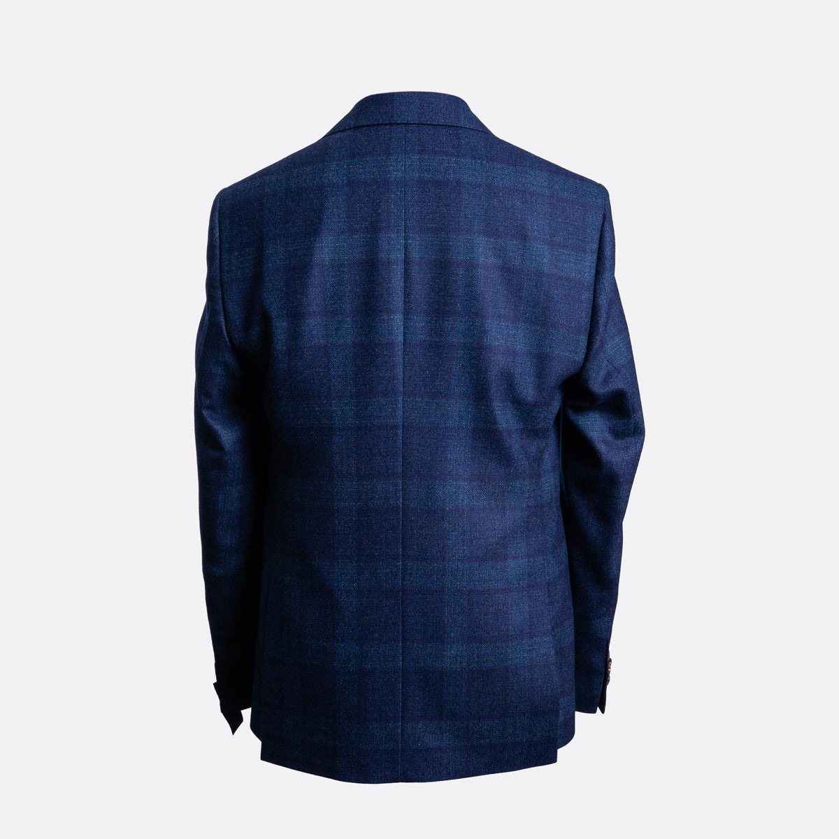 A navy blue plaid blazer shown from the back, displayed on a clean, light gray background. Sand Copenhagen Blazer available at Sakks Menswear in Southampton.