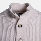 Close-up of a ribbed knit cardigan sweater in a light warm gray or greige color, featuring a high stand collar and three decorative buttons. Thomas Maine Jumper available at Sakks Menswear in Southampton.