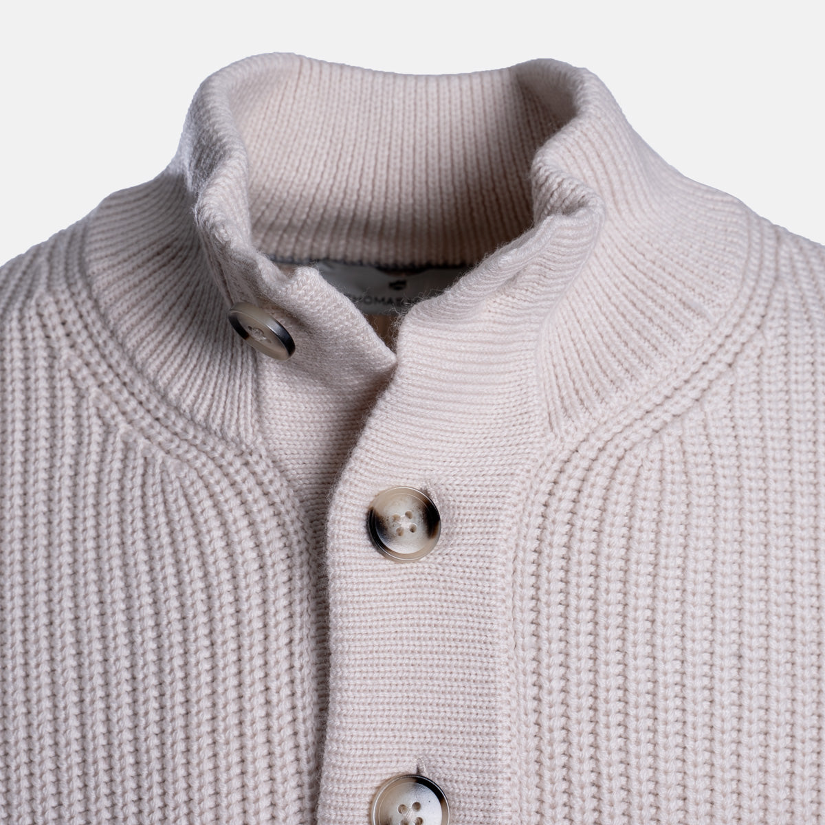 Close-up of a ribbed knit cardigan sweater in a light warm gray or greige color, featuring a high stand collar and three decorative buttons. Thomas Maine Jumper available at Sakks Menswear in Southampton.