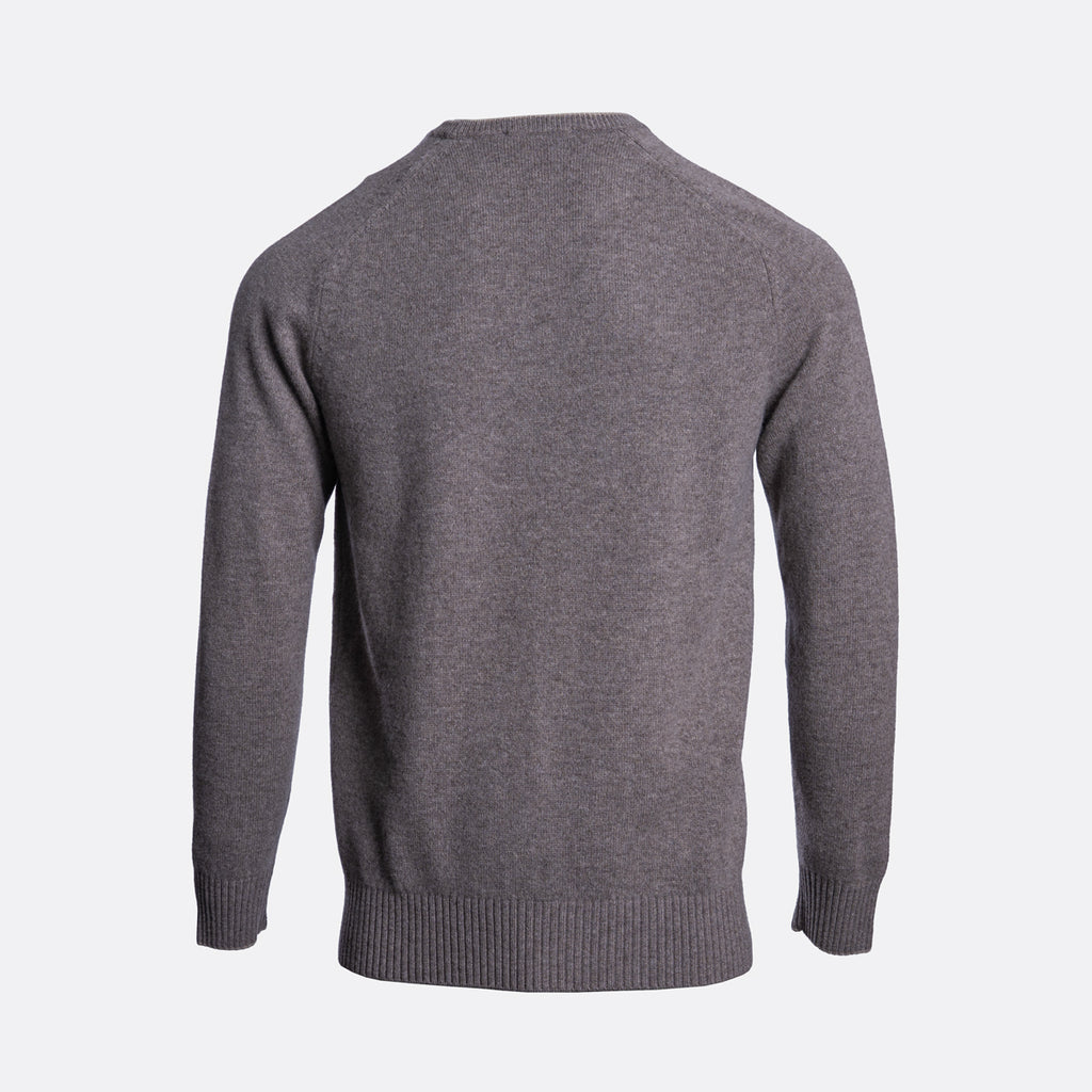 A dark gray knit sweater shown from the back, featuring a crew neck, long sleeves, and ribbed cuffs and hem, set against a plain light gray background. Thomas Maine Jumper available at Sakks Menswear in Southampton.