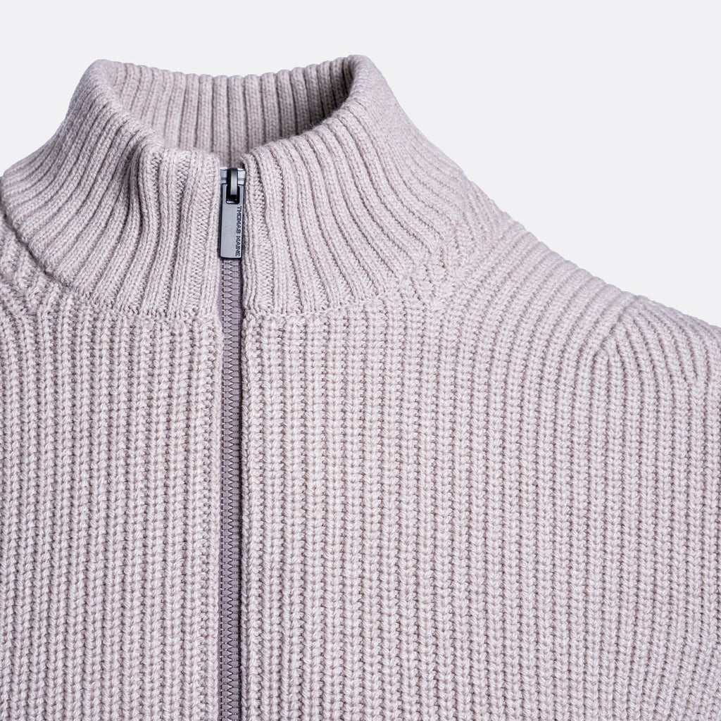 Close-up of a ribbed knit zip-up sweater in a light dusty lavender or pale purple color, showing the collar and zipper pull. Thomas Maine Cardigan available at Sakks Menswear in Southampton.