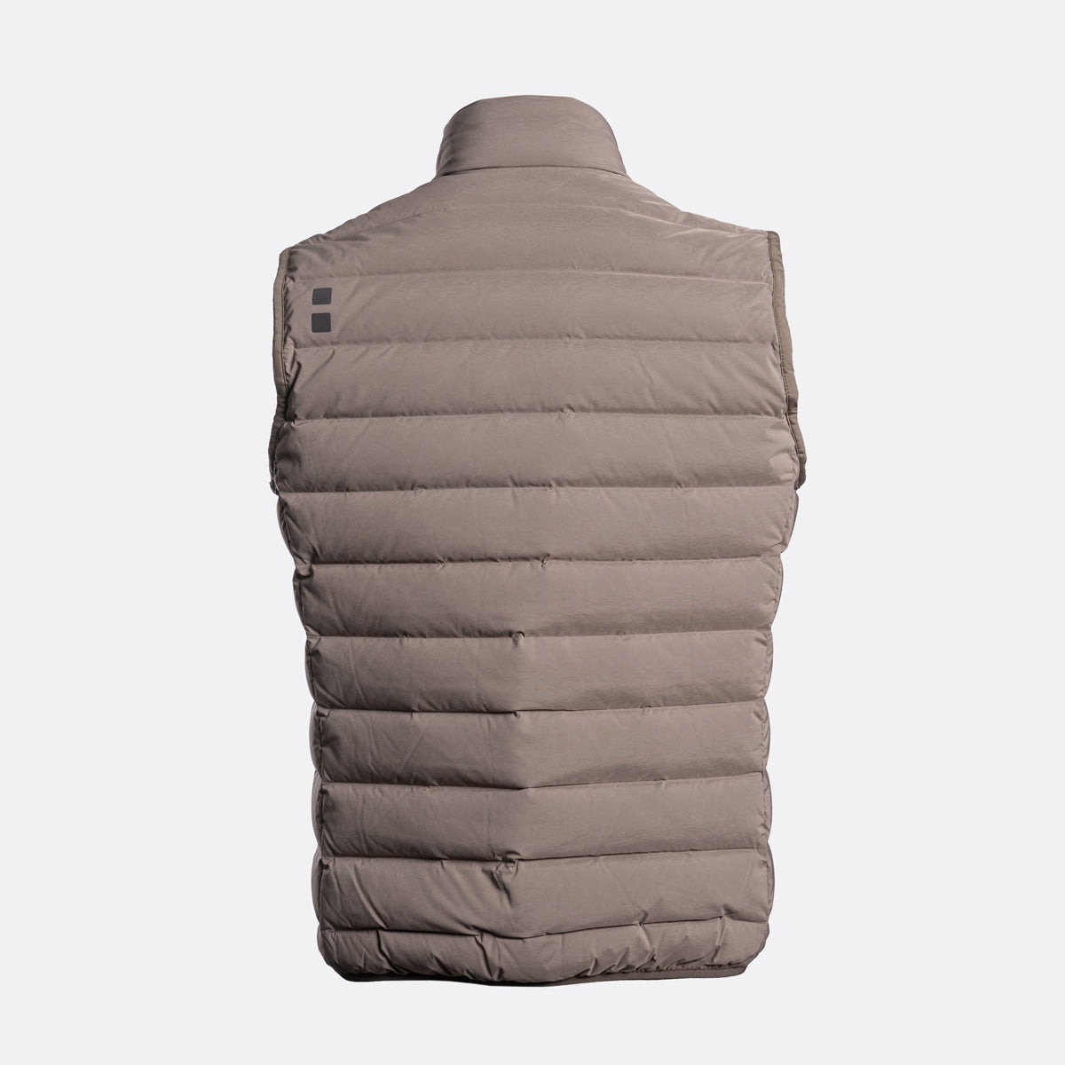 A sleeveless quilted puffer vest shown from the back, in a solid taupe-brown color, on a light gray background. UBR Gilet available at Sakks Menswear in Southampton.