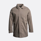 A taupe-brown longline utility jacket with a pointed collar, front zipper closure, and zippered hand pockets, shown on a light gray background. UBR Jacket available at Sakks Menswear in Southampton.
