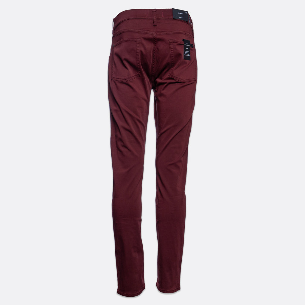 A pair of slim-fit jeans in a deep burgundy color, shown flat against a light gray background. 7 For All Mankind Slimmy Sateen Jeans. Sakks Menswear Southampton.