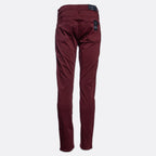 A pair of slim-fit jeans in a deep burgundy color, shown flat against a light gray background. 7 For All Mankind Slimmy Sateen Jeans. Sakks Menswear Southampton.