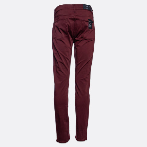 A pair of slim-fit jeans in a deep burgundy color, shown flat against a light gray background. 7 For All Mankind Slimmy Sateen Jeans. Sakks Menswear Southampton.