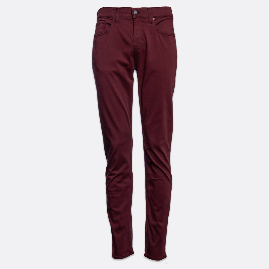A pair of slim-fit jeans in a deep burgundy color, shown flat against a light gray background. 7 For All Mankind Slimmy Sateen Jeans. Sakks Menswear Southampton.
