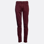 A pair of slim-fit jeans in a deep burgundy color, shown flat against a light gray background. 7 For All Mankind Slimmy Sateen Jeans. Sakks Menswear Southampton.