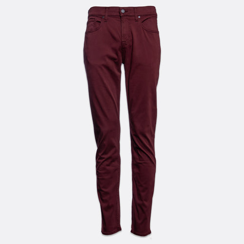 A pair of slim-fit jeans in a deep burgundy color, shown flat against a light gray background. 7 For All Mankind Slimmy Sateen Jeans. Sakks Menswear Southampton.