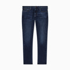 A pair of dark blue slim-fit jeans with subtle whiskering and fading on the thighs, shown flat against a solid white background. Emporio Armani Jeans available at Sakks Menswear in Southampton.
