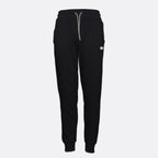 Black sweatpants with a light gray drawstring and a small white logo patch on the left thigh, shown against a light gray background. Emporio Armani Joggers available at Sakks Menswear in Southampton.