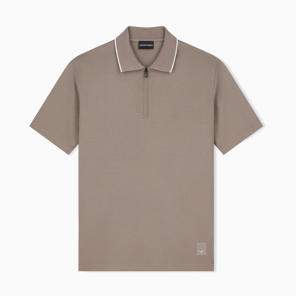 A taupe short-sleeve polo shirt with a half-zip collar and white piping trim, shown flat against a light gray background. Emporio Armani olo available at Sakks Menswear in Southampton.