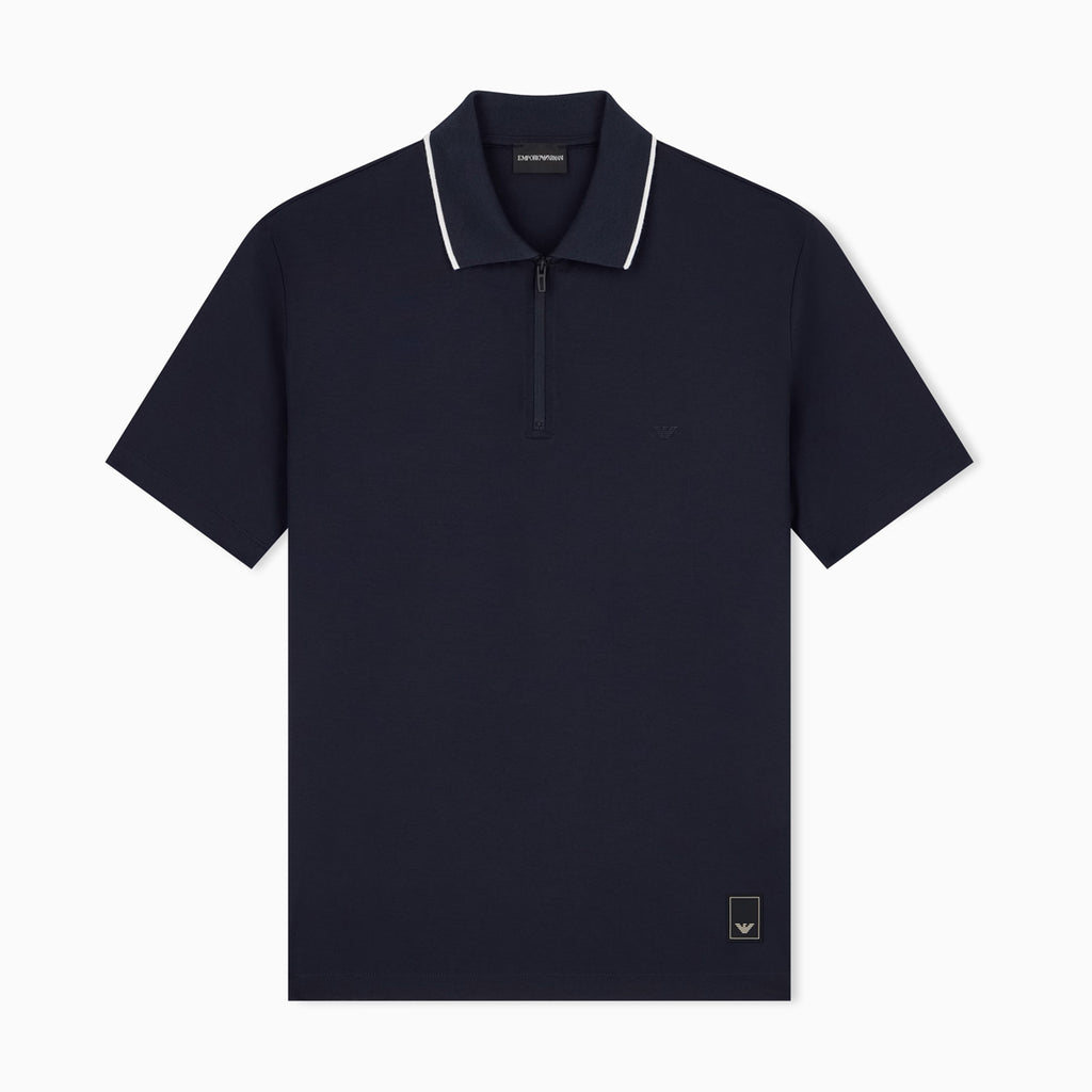 A navy blue short-sleeve polo shirt with a half-zip collar and white piping trim, shown flat against a light gray background. Emporio Armani Polo available at Sakks Menswear in Southampton.