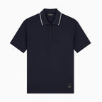 A navy blue short-sleeve polo shirt with a half-zip collar and white piping trim, shown flat against a light gray background. Emporio Armani Polo available at Sakks Menswear in Southampton.
