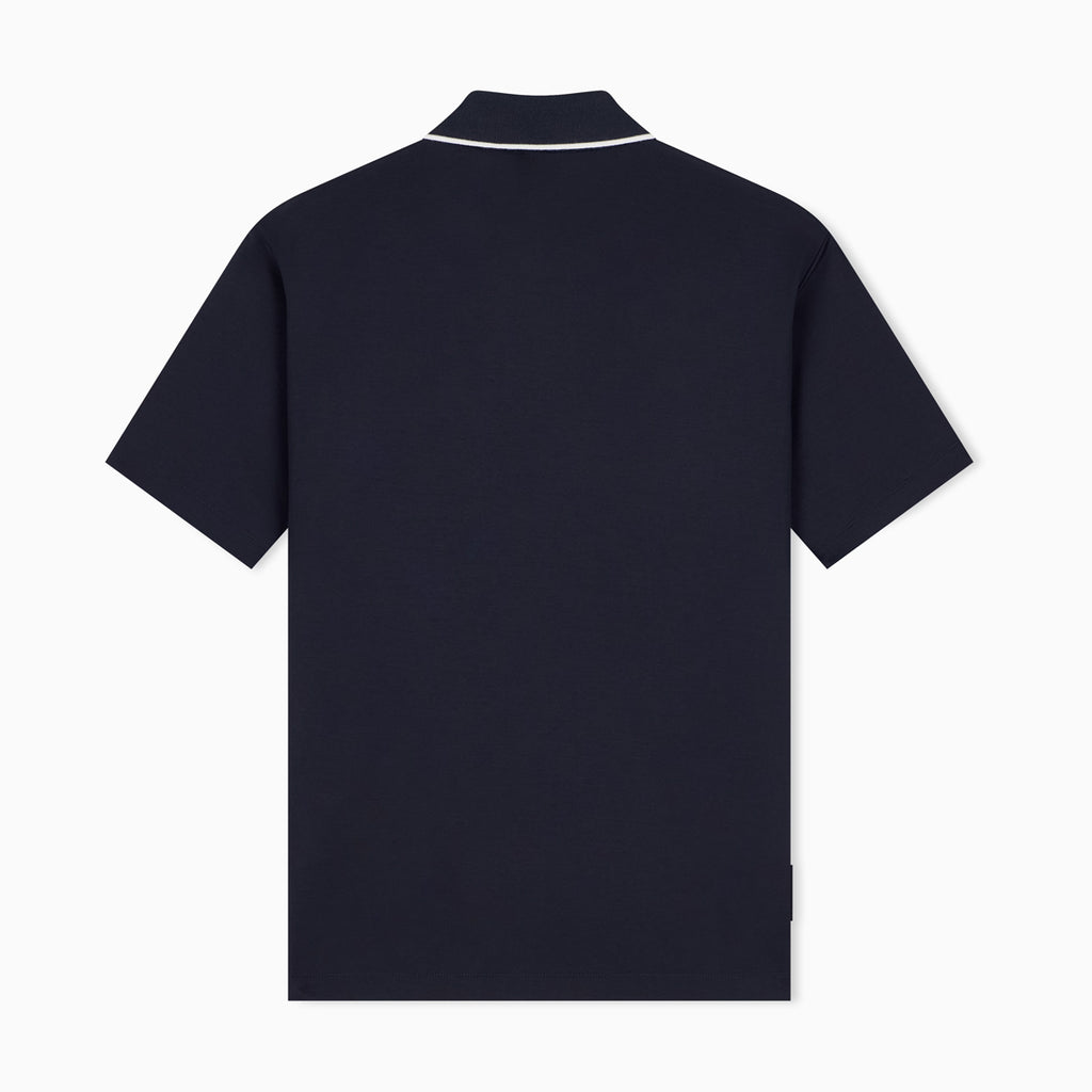 A dark navy blue short-sleeve polo shirt shown from the back, featuring a white contrast trim along the collar, set against a plain white background. Emporio Armani Polo available at Sakks Menswear in Southampton.