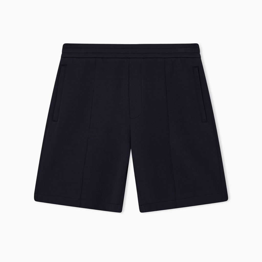 A pair of dark navy blue pleated shorts with side pockets, shown flat against a clean white background. Emporio Armani Shorts available at Sakks Menswear in Southampton.