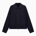 A dark navy blue lightweight jacket with a collar, front zipper, and zippered chest pocket, displayed flat against a light gray background. Emporio Armani Jacket available at Sakks Menswear in Southampton.