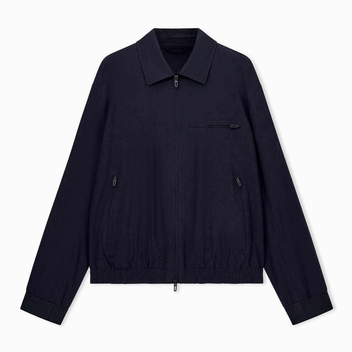 A dark navy blue lightweight jacket with a collar, front zipper, and zippered chest pocket, displayed flat against a light gray background. Emporio Armani Jacket available at Sakks Menswear in Southampton.