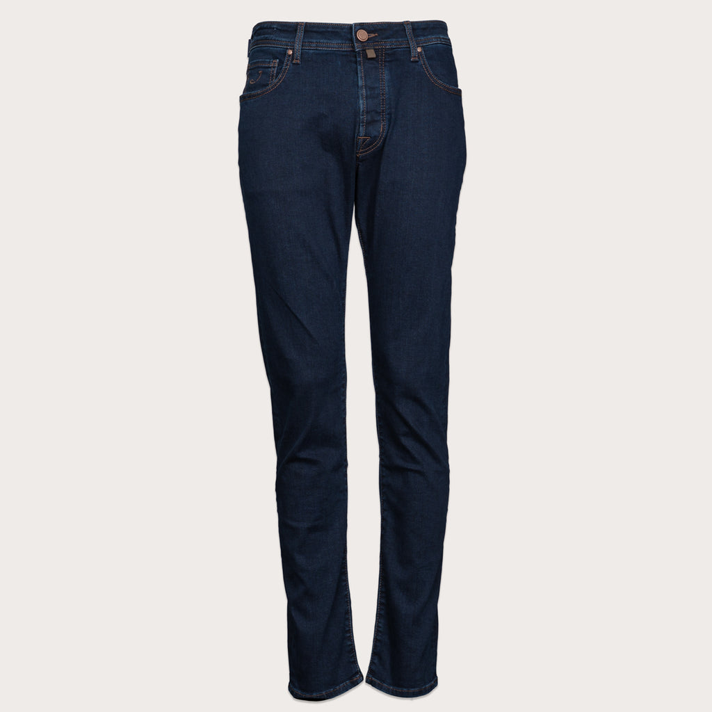 A pair of dark navy blue slim-fit jeans shown flat against a light gray background. Jacob Cohen Jeans available at Sakks Menswear in Southampton.
