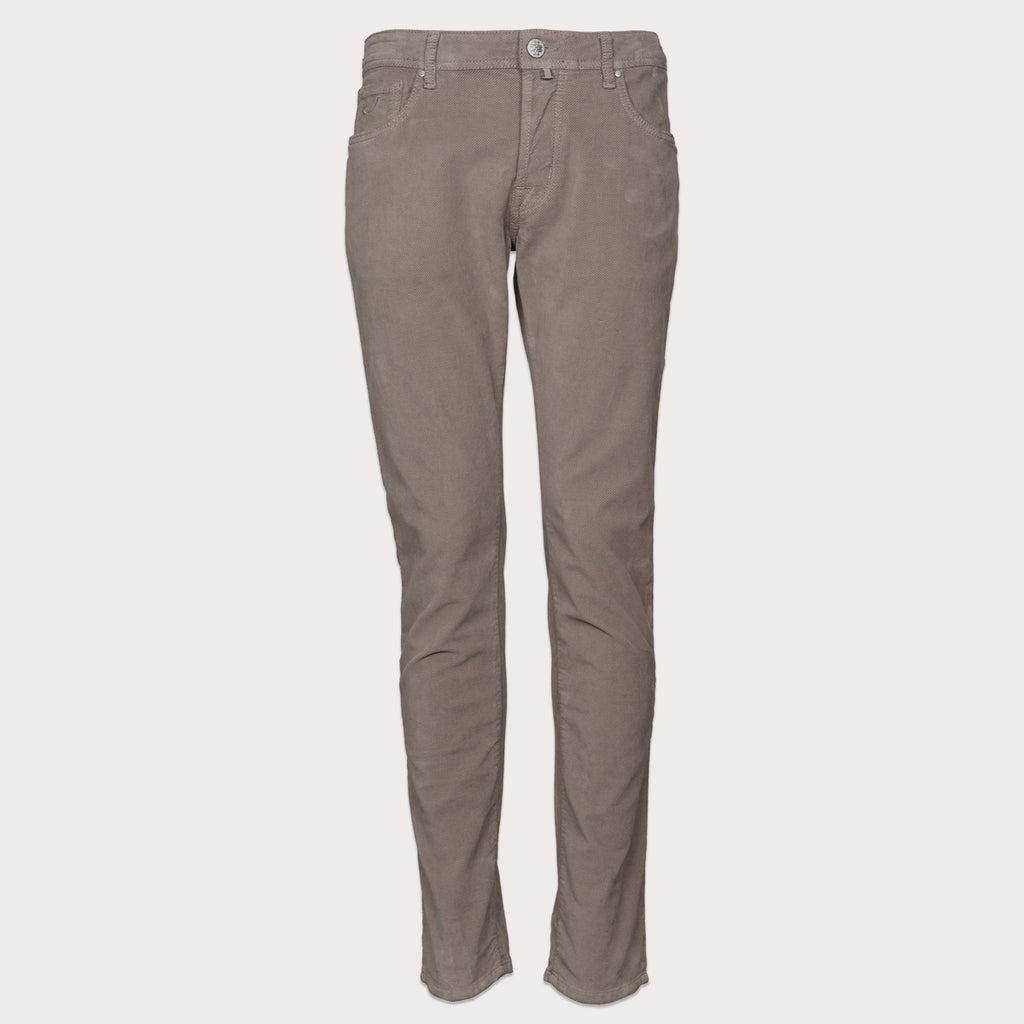 A pair of slim-fit trousers in a muted taupe-brown color, shown flat against a light beige background. Jacob Cohen Trousers available at Sakks Menswear in Southampton.