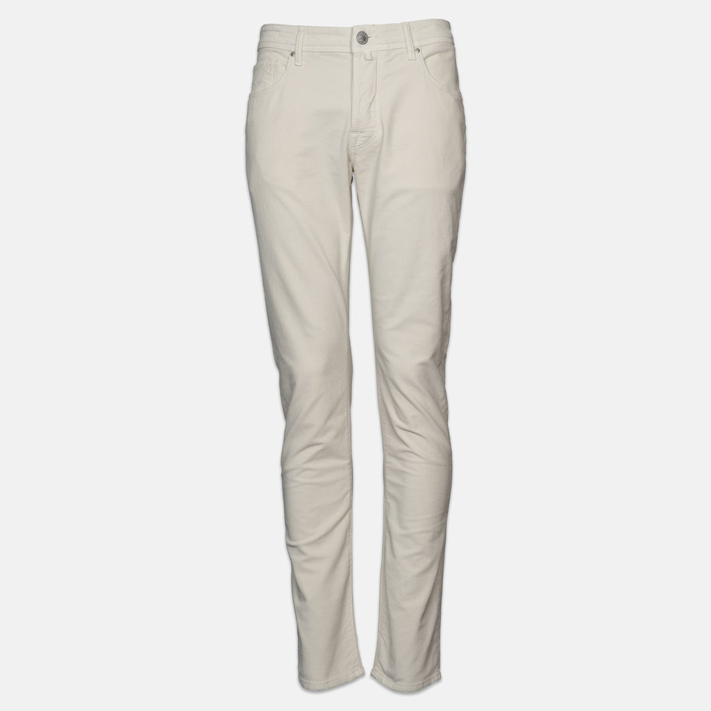 A pair of slim-fit, straight-leg jeans in a light cream or off-white color, displayed on a clean, light gray background. Jacob Cohen Jeans available at Sakks Menswear in Southampton.