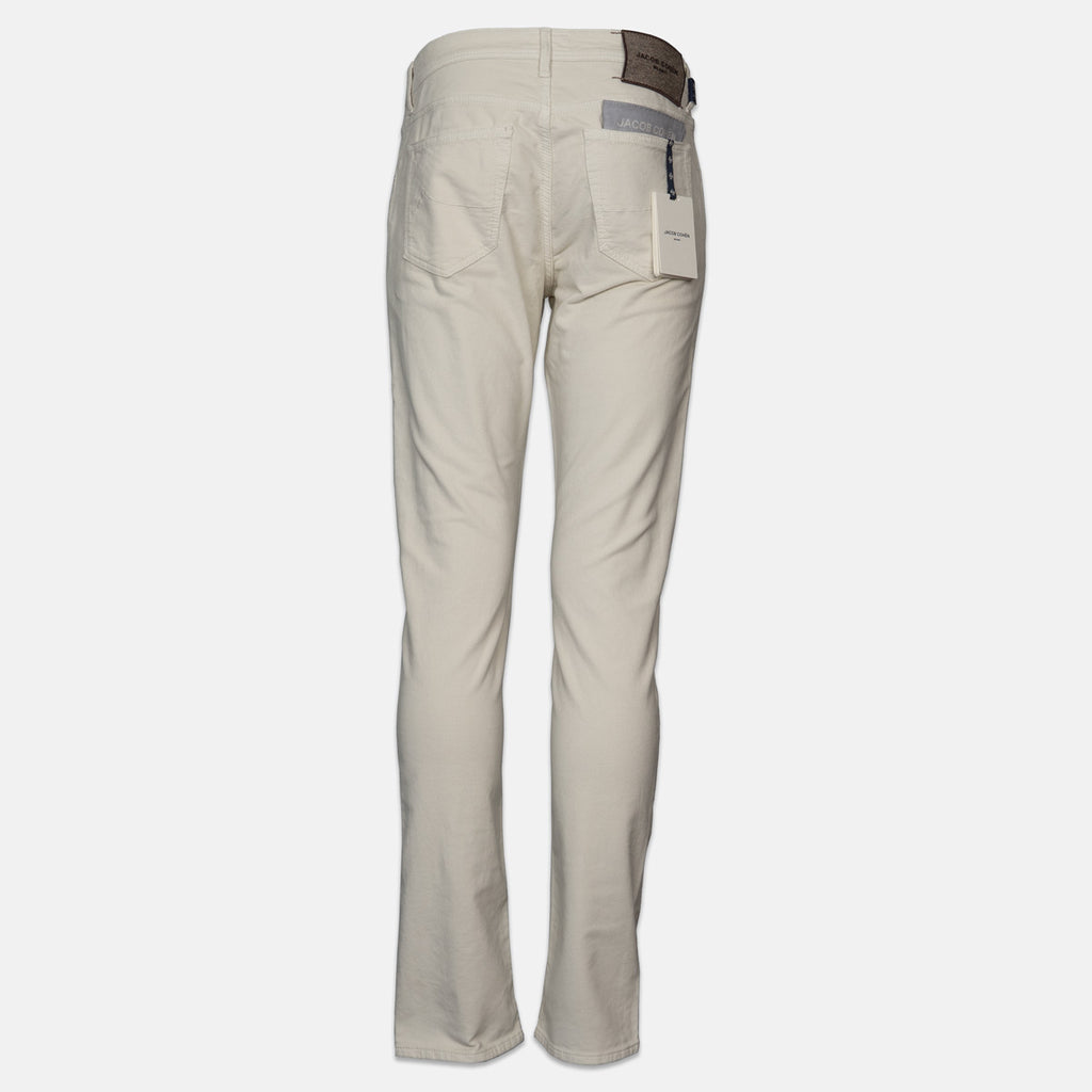 Beige straight-leg trousers shown from the back, featuring a brown leather patch at the waistband and a gray reflective safety strip on the back pocket, set against a plain light gray background. Jacob Cohen Jeans available at Sakks Menswear in Southampton.