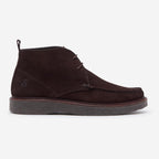 A dark brown suede moccasin boot with a thick dark gray sole, shown in a side profile on a light gray background. Oliver Sweeney Moccasin's available at Sakks Menswear in Southampton.