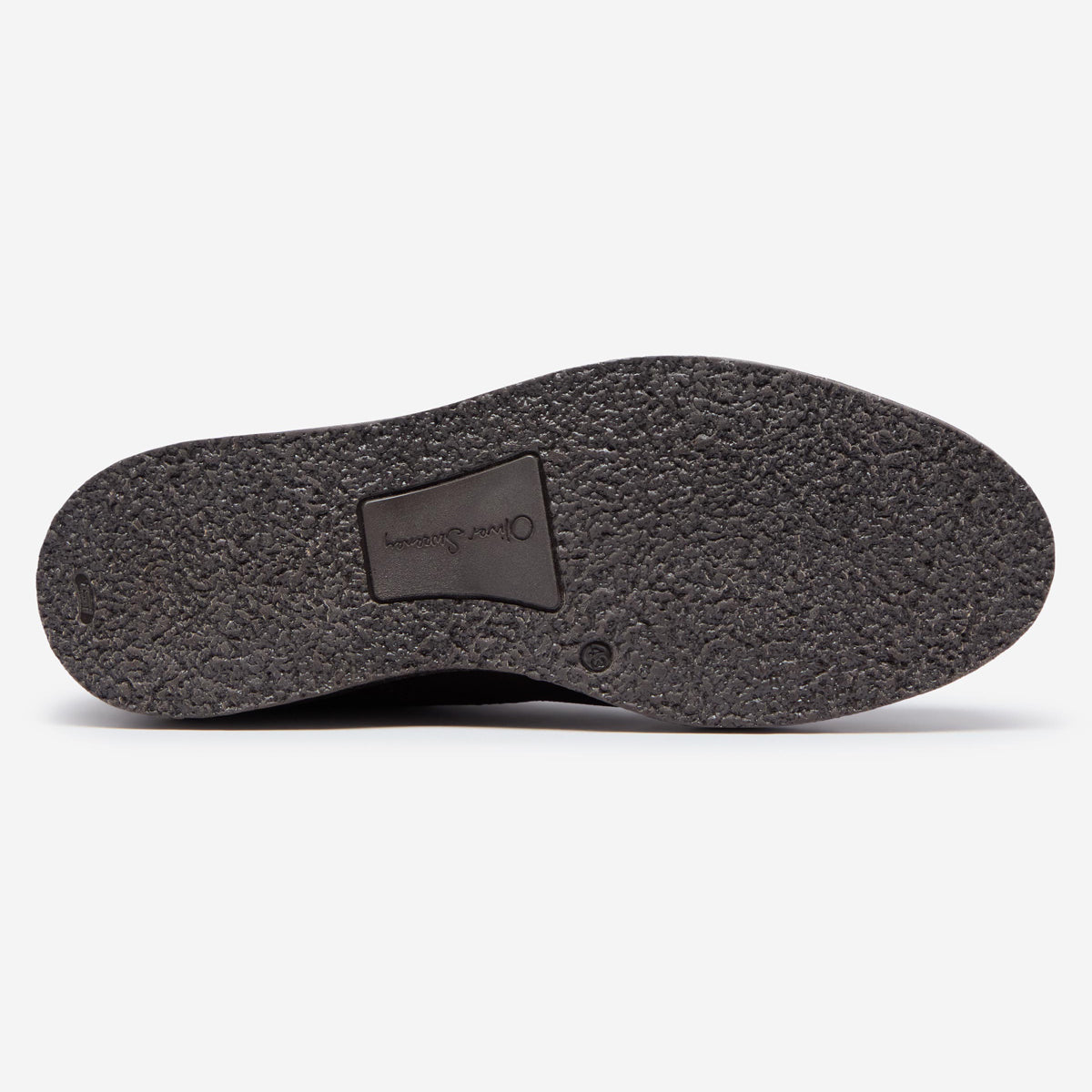 The textured black rubber outsole of a shoe, showing a central brand patch that reads 'Oliver Sweeney' on a clean white background. Oliver Sweeney Moccasin's available at Sakks Menswear in Southampton.