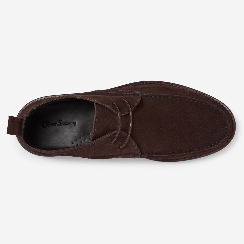 A single dark brown suede moc-toe shoe shown from a top-down view on a light gray background. The brand name 'Oliver Sweeney' is visible on the black interior footbed. Oliver Sweeney Moccasin's available at Sakks Menswear in Southampton.