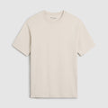 A light beige crewneck t-shirt with short sleeves, displayed flat against a light gray background. The brand name 'Oliver Sweeney' is visible in small script on the inner neck label. Oliver Sweeney T-Shirt available at Sakks Menswear in Southampton.