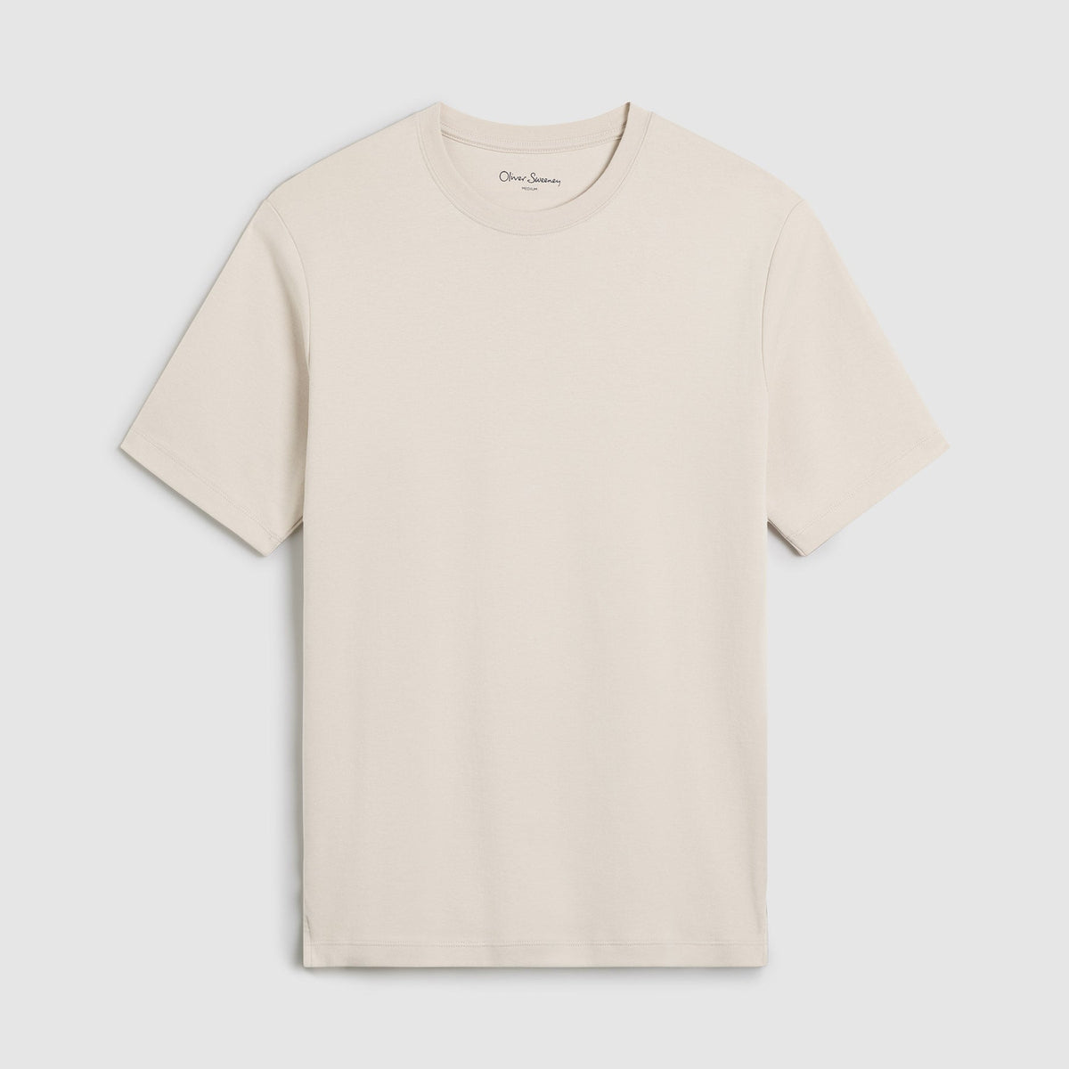 A light beige crewneck t-shirt with short sleeves, displayed flat against a light gray background. The brand name 'Oliver Sweeney' is visible in small script on the inner neck label. Oliver Sweeney T-Shirt available at Sakks Menswear in Southampton.