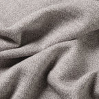 A close-up of draped heather gray fabric with a soft, woven texture filling the entire frame. Oliver Sweeney Sweater available at Sakks Menswear in Southampton.
