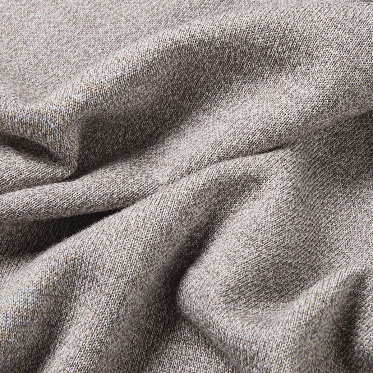 A close-up of draped heather gray fabric with a soft, woven texture filling the entire frame. Oliver Sweeney Sweater available at Sakks Menswear in Southampton.
