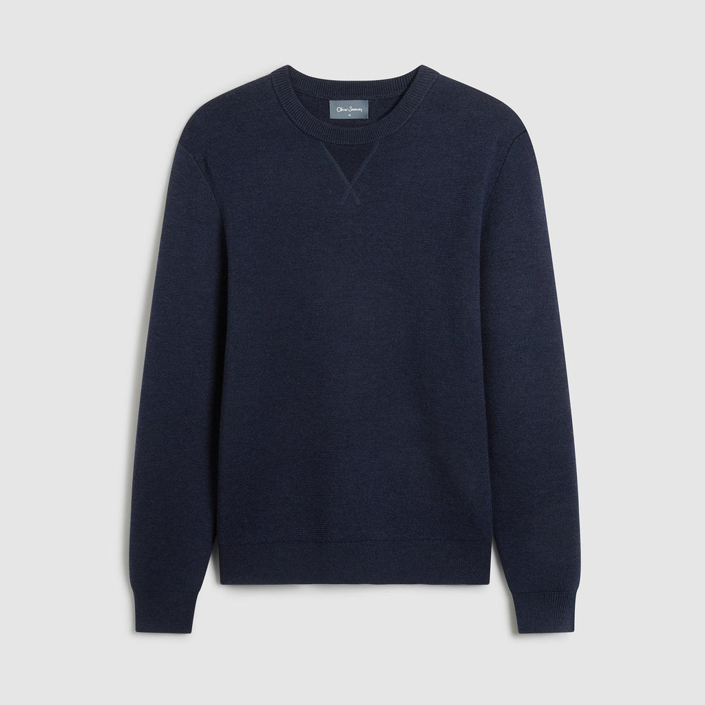 A dark navy blue crewneck sweater displayed flat against a light gray background. Oliver Sweeney Sweater available at Sakks Menswear in Southampton.
