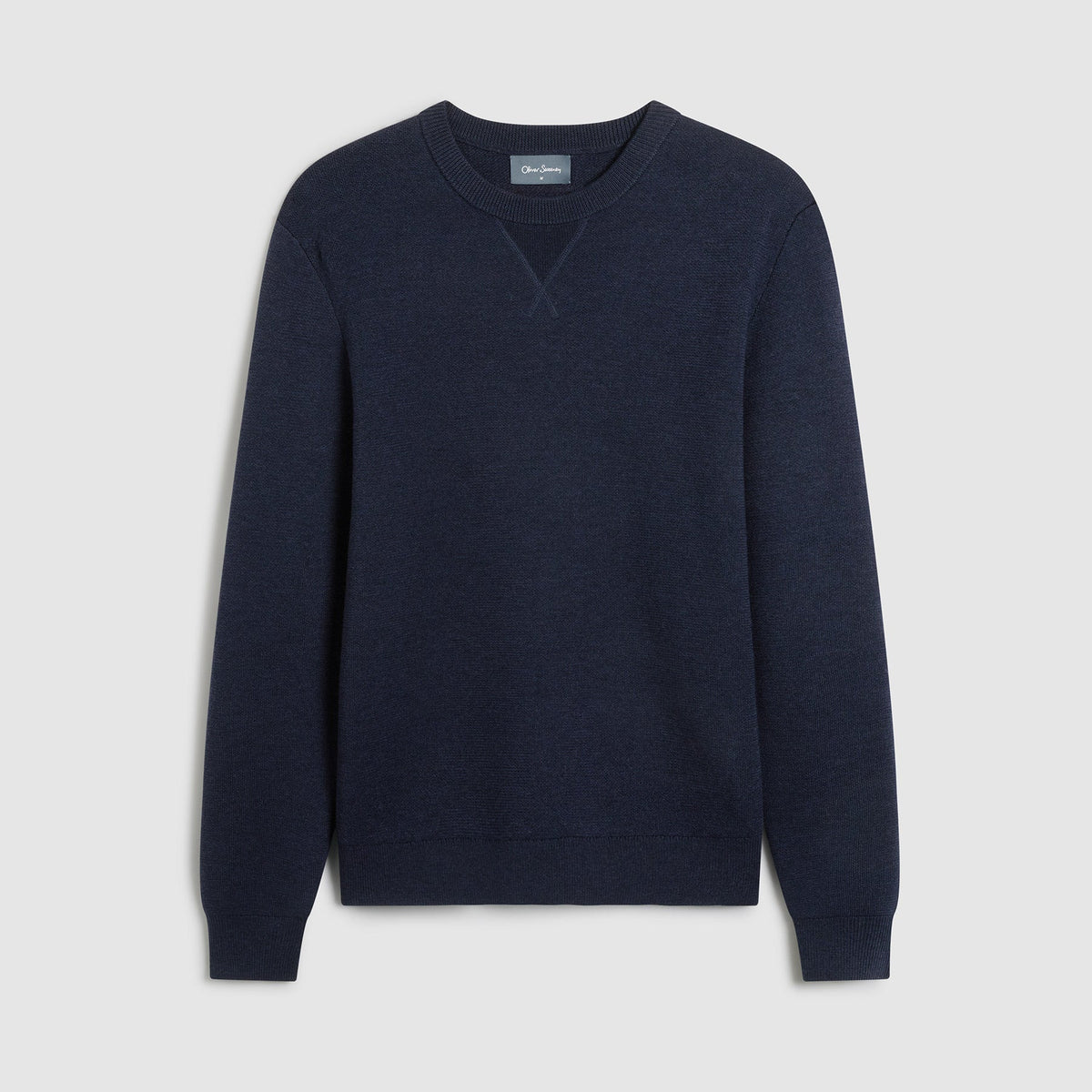 A dark navy blue crewneck sweater displayed flat against a light gray background. Oliver Sweeney Sweater available at Sakks Menswear in Southampton.