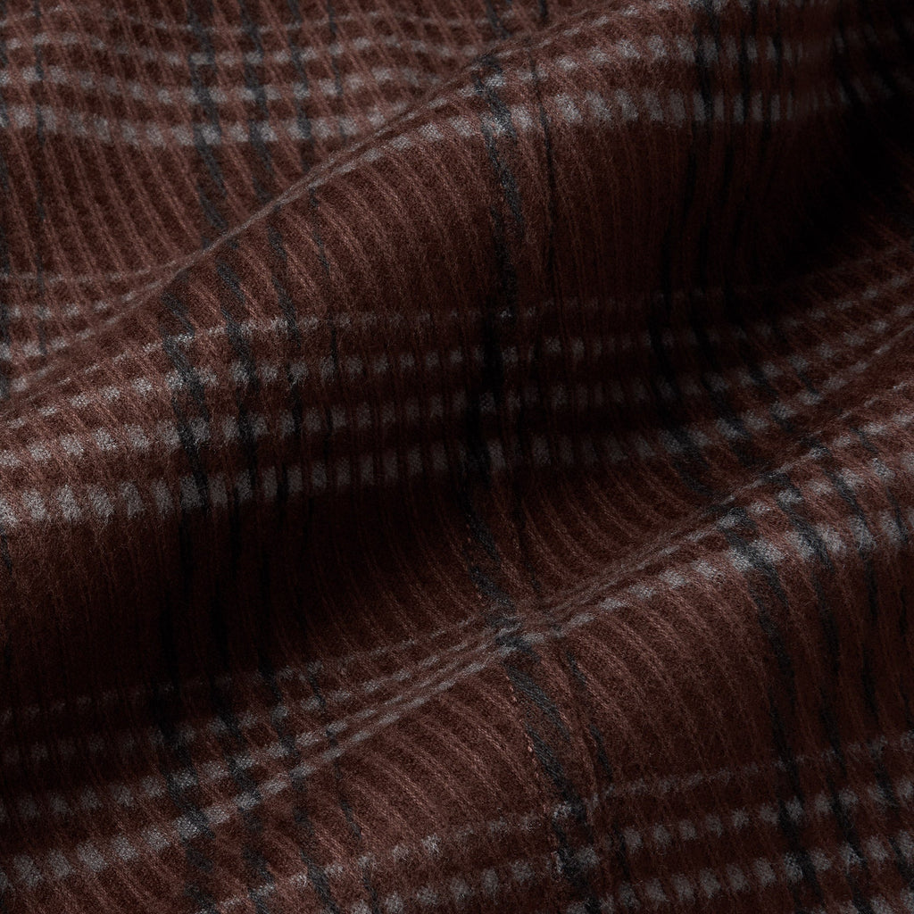 A close-up of a brown plaid fabric with a fine checkered pattern in dark brown, black, and light beige. Oliver Sweeney Shirt Jacket available at Sakks Menswear in Southampton.