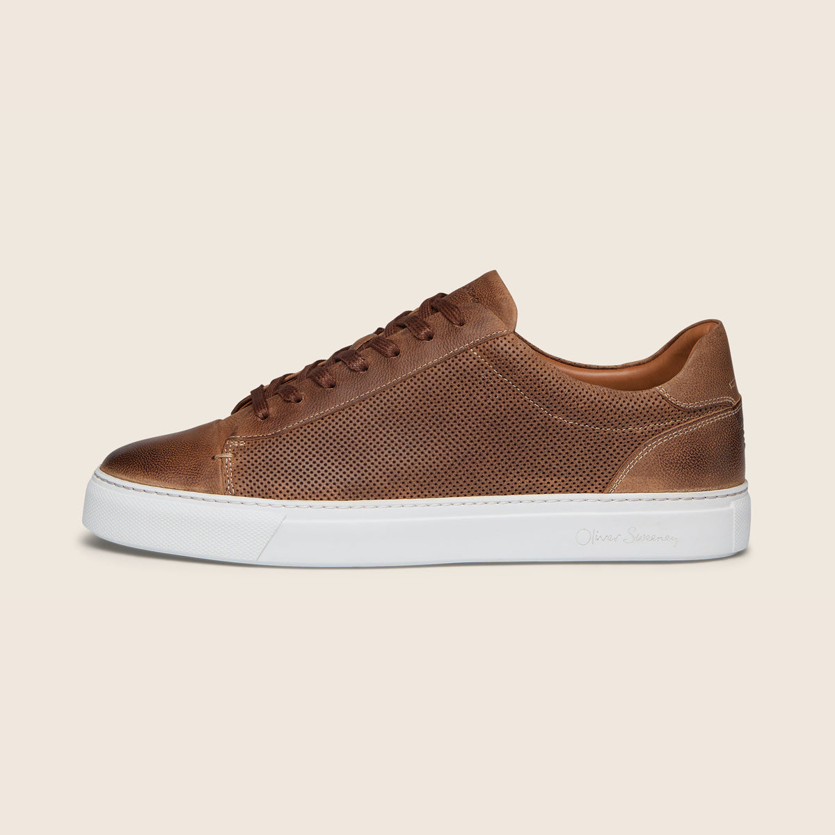 A gray athletic sneaker with a quilted upper, gray laces, a black heel tab, and a thick white midsole, shown from a side profile view on a white background. Oliver Sweeney Trainers available at Sakks Menswear in Southampton.