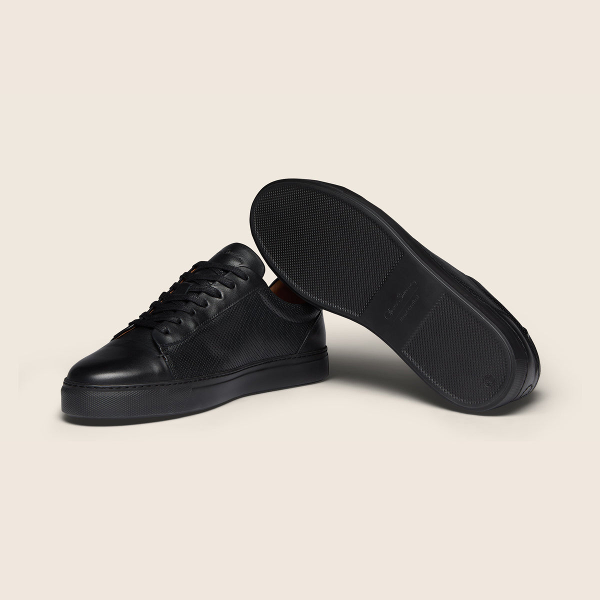 Black cloth on a white background. Oliver Sweeney Trainers available at Sakks Menswear in Southampton.