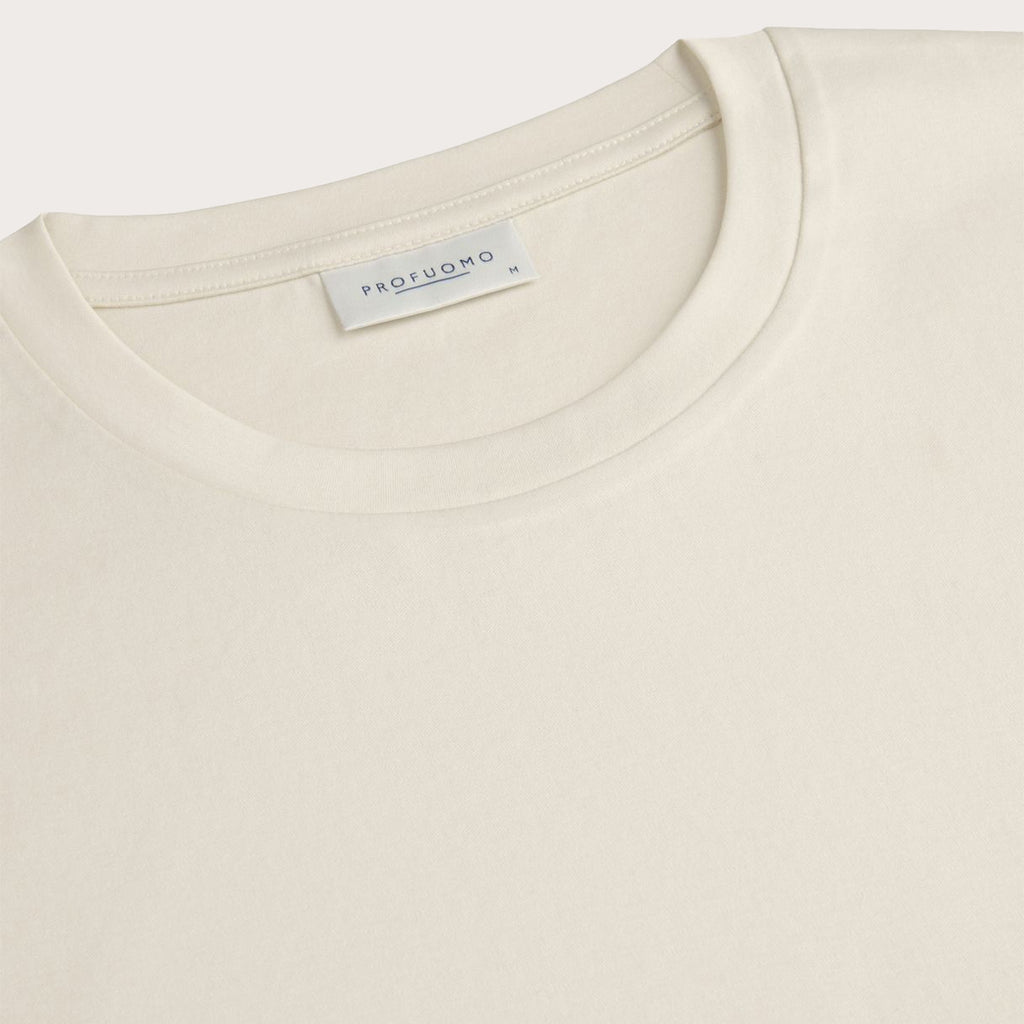 A close up of the crew neck collar of a Off-White Pima Cotton T-shirt placed in-front of a light grey background. Profuomo T-Shirts are available at Sakks Menswear in Southampton.
