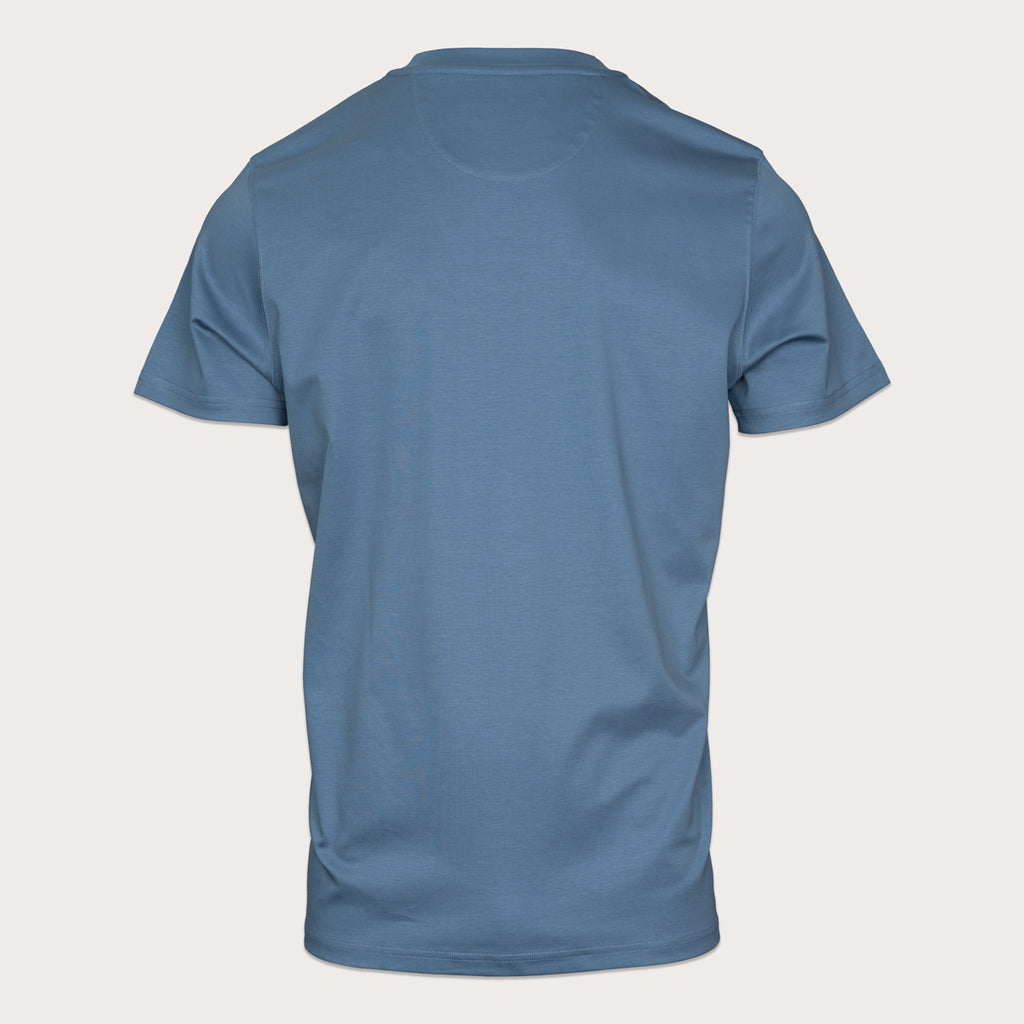 A blue short-sleeve crewneck t-shirt shown from the back, displayed on a light beige background. Thomas Maine T-Shirts available at Sakks Menswear in Southampton.