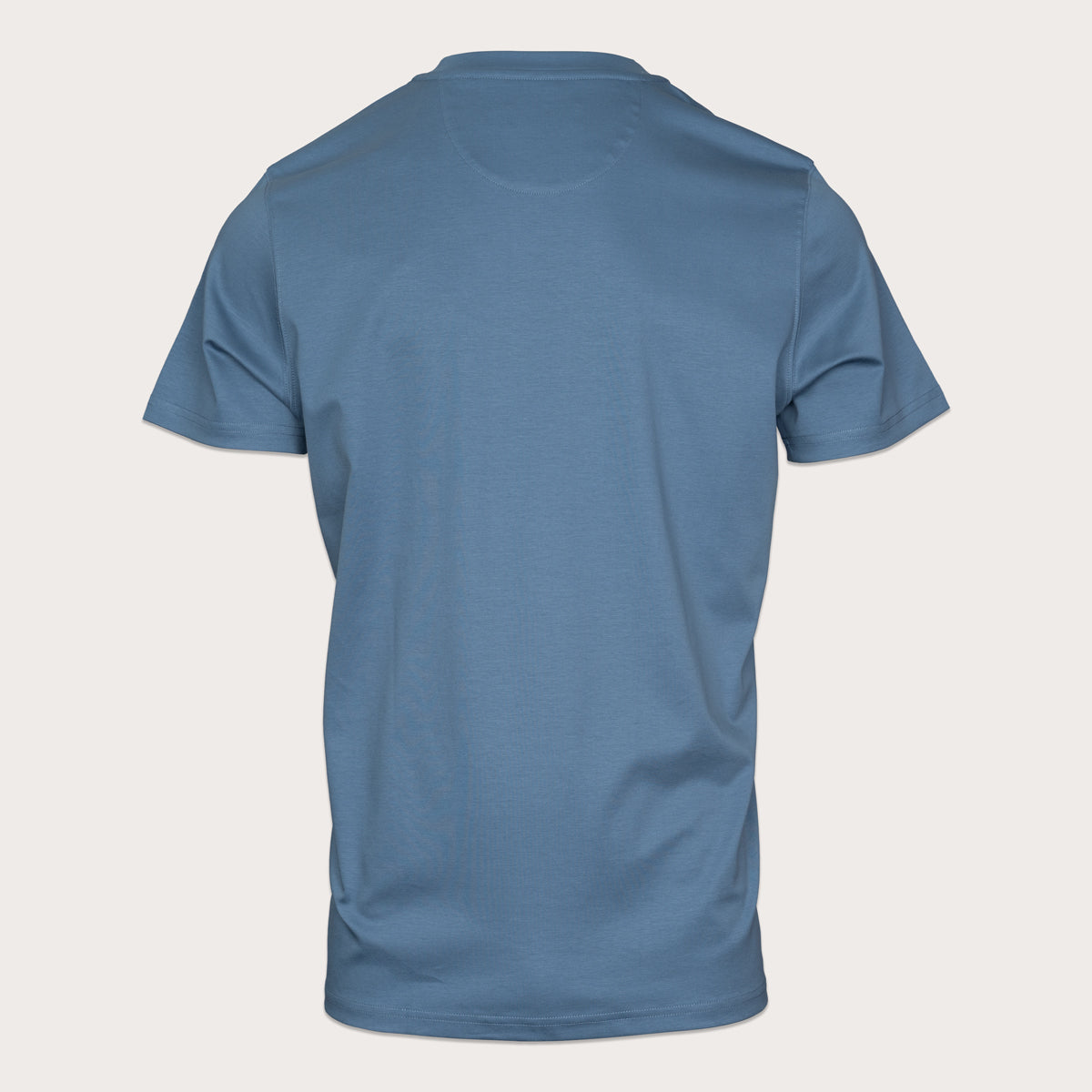 A blue short-sleeve crewneck t-shirt shown from the back, displayed on a light beige background. Thomas Maine T-Shirts available at Sakks Menswear in Southampton.