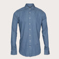 A medium blue chambray long-sleeve button-down shirt with a classic collar and white buttons, displayed on a neutral light beige background. Thomas Maine Shirt available at Sakks Menswear in Southampton.