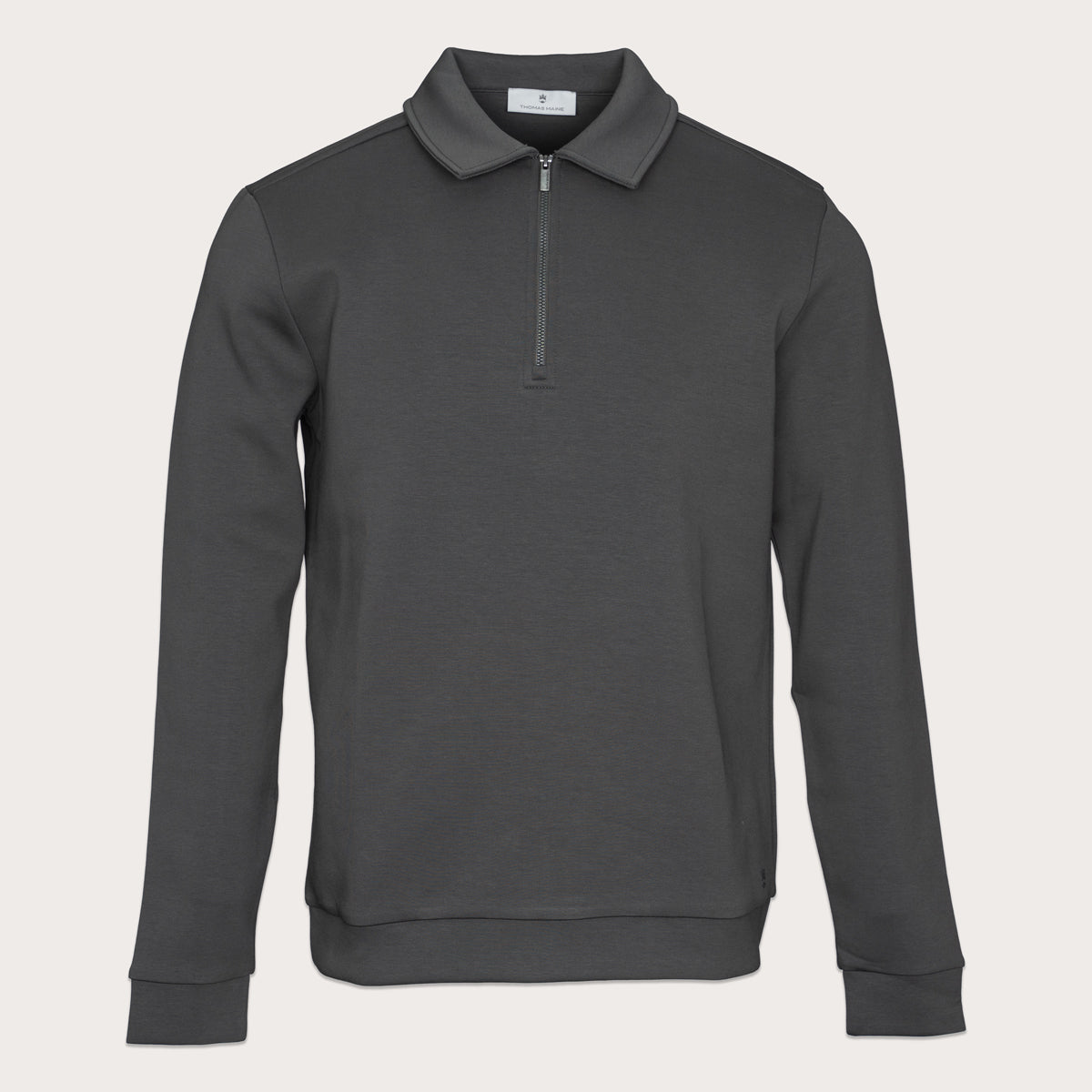 A dark gray long-sleeve quarter-zip pullover sweatshirt with a classic collar, displayed on a clean, light beige background. Thomas Maine Sweatshirt available at Sakks Menswear in Southampton.