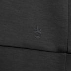 Close-up of dark heather gray ribbed fabric with a tonal embossed crown crest logo near the center. Thomas Maine Sweatshirt available at Sakks Menswear in Southampton.