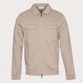 A light beige zip-up jacket with a pointed collar, two flap chest pockets, and side pockets, shown on a solid off-white background. Thomas Maine Sweats available at Sakks Menswear in Southampton.