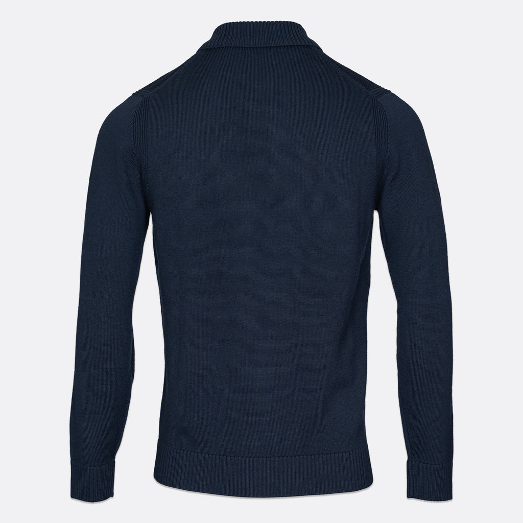 A dark navy blue knit sweater shown from the back, featuring a mock neck collar, ribbed cuffs, and a ribbed hem, displayed on a light gray background. Thomas Maine Knitwear available at Sakks Menswear in Southampton.