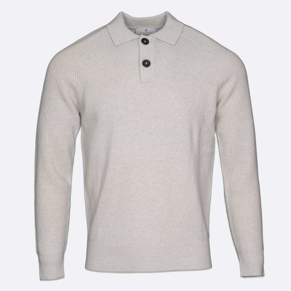 A light beige ribbed knit polo sweater with a two-button placket, displayed on a clean white background. Thomas Maine Knitwear available at Sakks Menswear in Southampton.